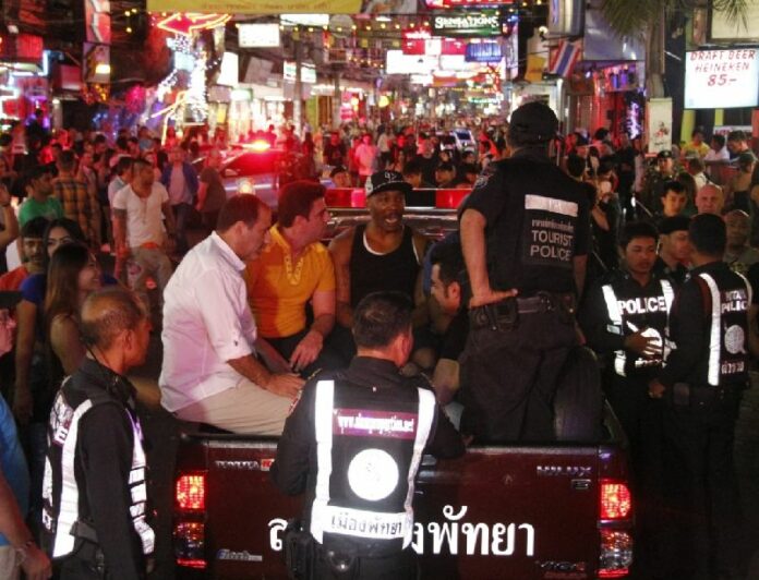 Police arrest foreigners for allegedly working without permits on Pattaya's Walking Street in this Dec. 22 photo.