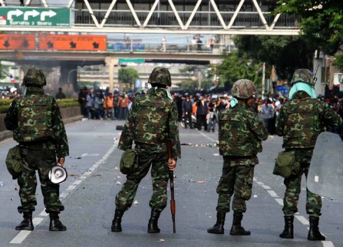 In this May 14, 2010, file photo, soldiers face off with Redshirt protesters on Rama IV Road in Bangkok.