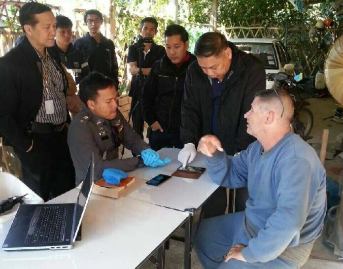 DSI and local police officers arresting Fabian Frederick Blandford at his home in Chiang Mai province yesterday.
