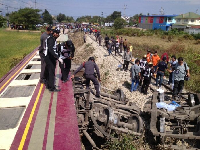 Police and Railway officers examine the damage from the train derailment this morning.