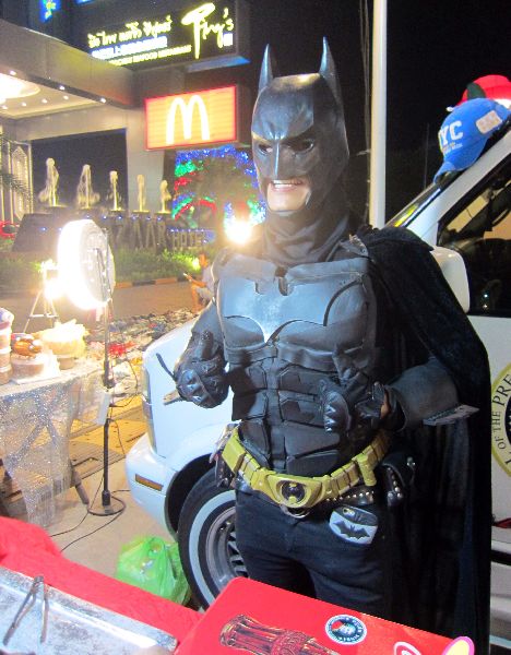A man in a Batman costume sells duck-shaped jelly at Suan Lum Night Bazaar.