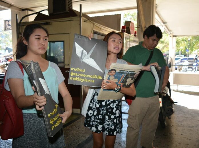 New Democracy Movement activists distribute anti-junta newsletters on Jan. 9, 2015, at Bangkok Railway Station.
