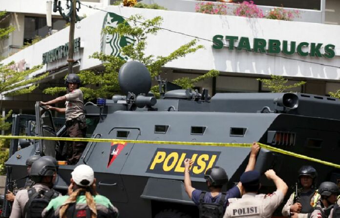 A police vehicle sits outside a Starbucks in Jakarta near the scene where suicide bombers and gunmen attacked Thursday. Photo: Darren Whiteside / Reuters
