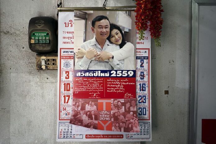 A New Year calendar showing a picture of former Prime Ministers Thaksin and Yingluck Shinawatra hangs Jan. 6 inside a Bangkok restaurant. Photo: Athit Perawongmetha / Reuters