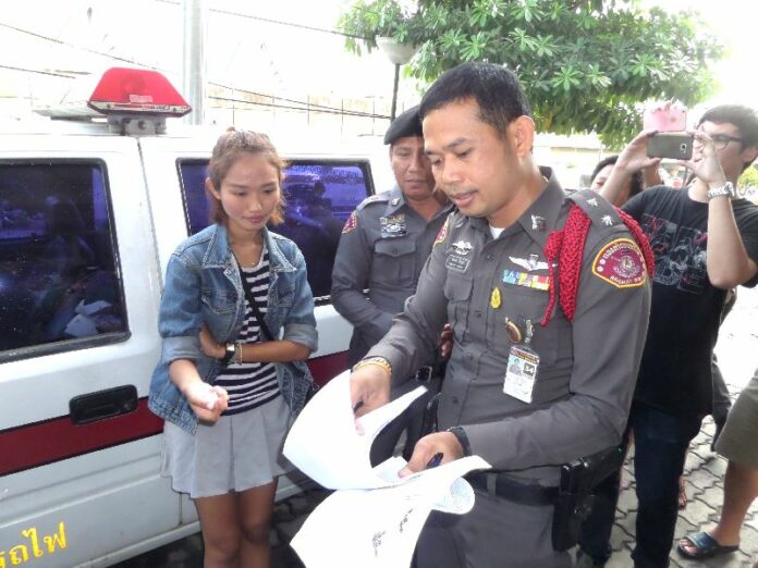 Police show Chonticha Jaeng-rew her arrest warrant today in front of Thonburi Railway Police Station.