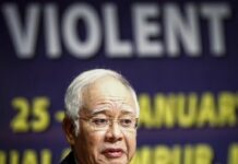 Defeated Malaysian Leader to Go on Holiday, Denies Fleeing