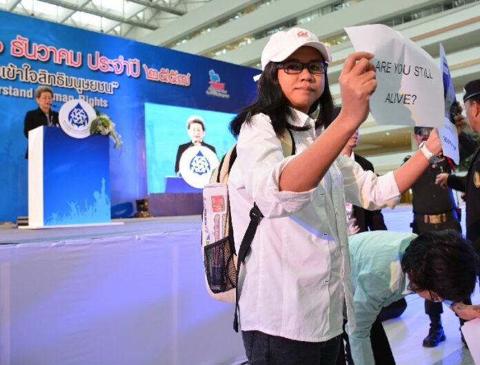 Pro-democracy activists crash an award ceremony Dec. 12, 2014, to criticize the National Human Rights Commission’s unwillingness to defend rights in the junta-ruled Thailand.