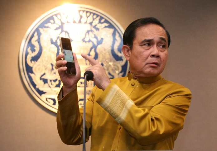 Gen. Prayuth Chan-ocha speaks to reporters Tuesday at Government House in Bangkok