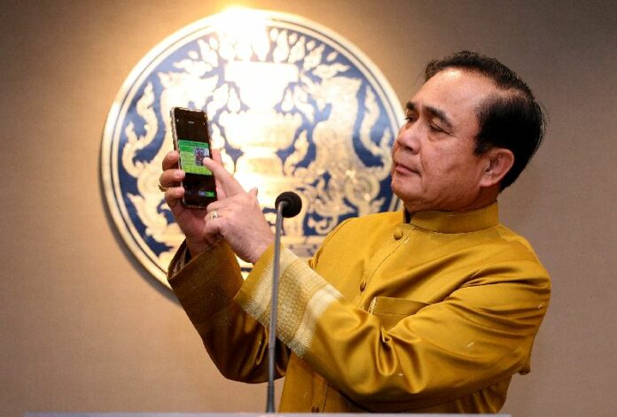 Junta leader Prayuth Chan-ocha speaks to reporters on Jan. 26 at Government House.