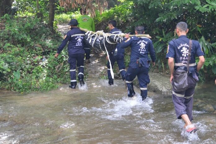 Rescue workers carry away the body of 18-year-old Passakorn Kongsawasdi on Sunday in Trang province.