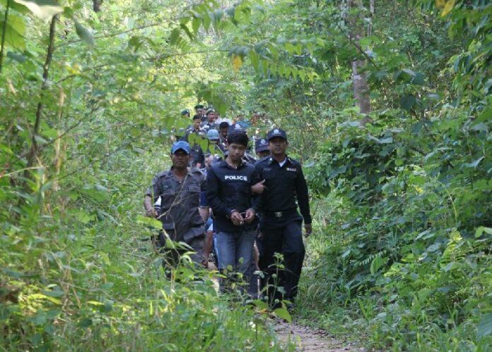 Police lead four suspects in a “reenactment” Tuesday to the spot in the jungle in Phatthalung province where they allegedly murdered a man and sexually assaulted his girlfriend Jan. 31.