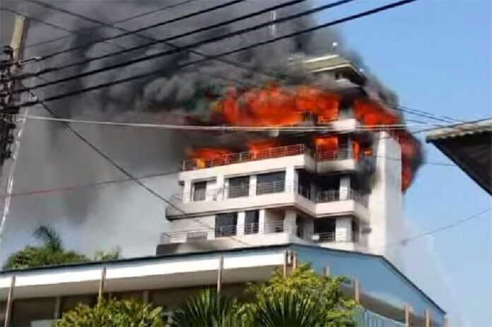 Still image from a video showing the fire Friday afternoon at a building on Soi Narathiwas 18.