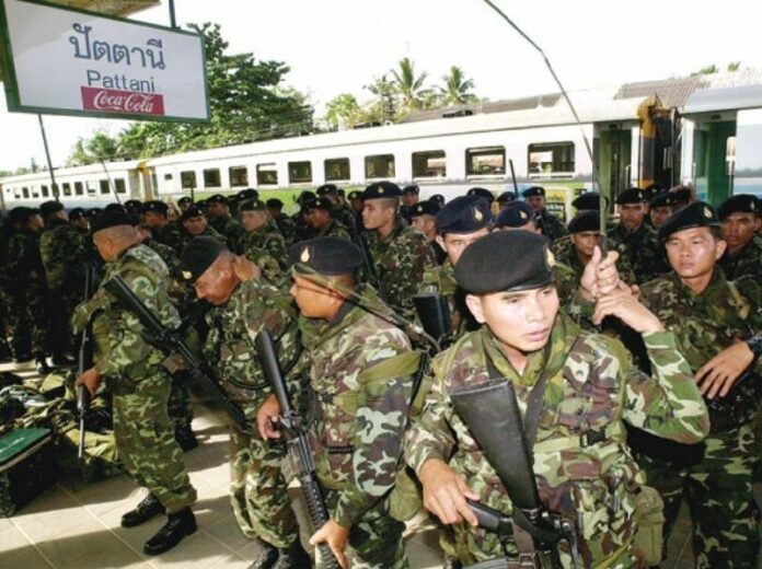 Embarking on a campaign of pacification under the government of former Prime Minister Thaksin Shinawatra, the first wave of soldiers arrive in Pattani in this May 2004 file photo.