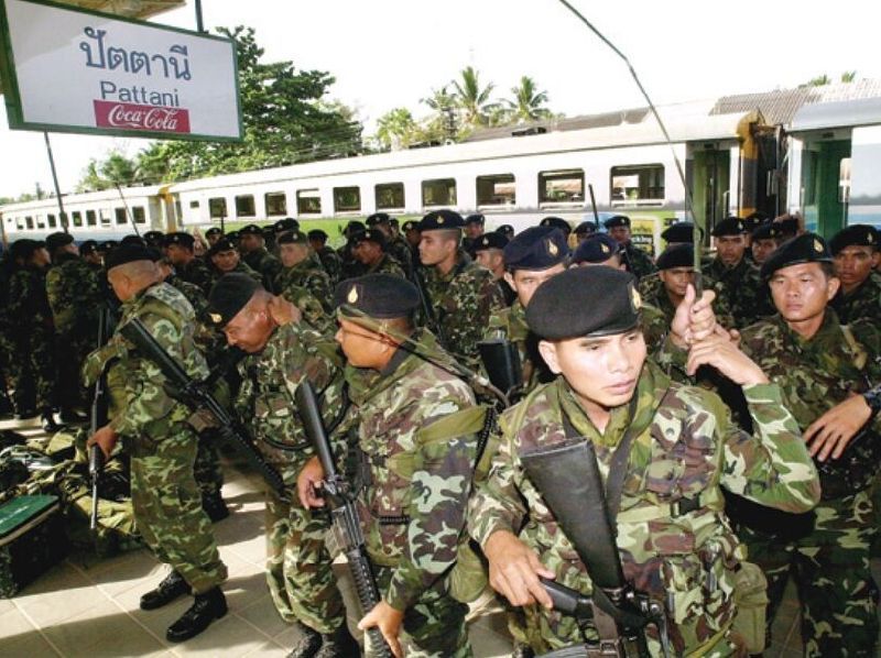 Embarking on a campaign of pacification under the government of former Prime Minister Thaksin Shinawatra, the first wave of soldiers arrive in Pattani in this May 2004 file photo.