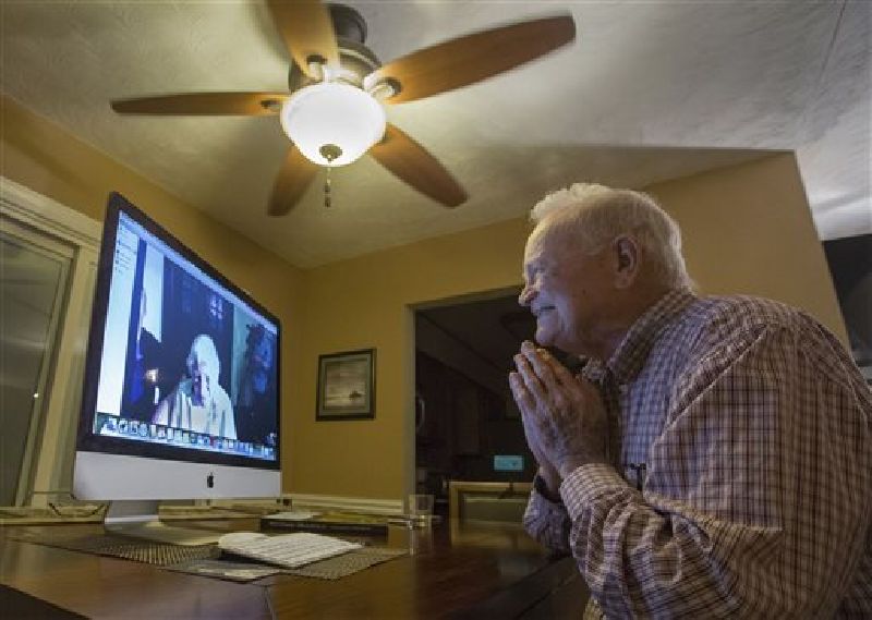 In this photo taken Nov. 6, 2015, Norwood Thomas, 93, talks with Joyce Morris via Skype from his home in Virginia Beach, Va. Photo: Bill Tiernan / The Virginian-Pilot / AP