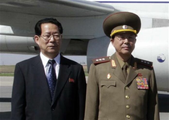 In this May 22, 2013 file photo, Kim Hyong Jun, left, deputy minister Foreign Affairs, and Ri Yong Gil, col. gen. of the Korean People's Army, pose before leaving Pyongyang Airport in North Korea for China. Photo: Associated Press