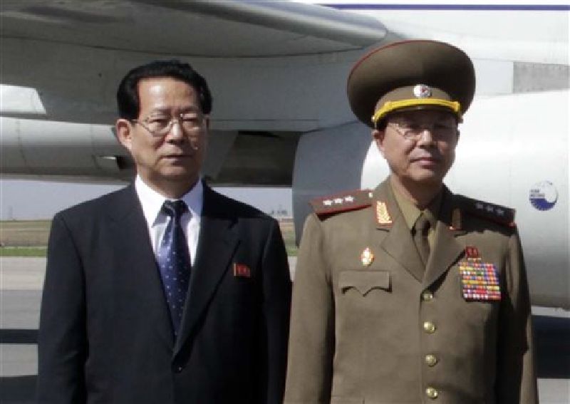 In this May 22, 2013 file photo, Kim Hyong Jun, left, deputy minister Foreign Affairs, and Ri Yong Gil, col. gen. of the Korean People's Army, pose before leaving Pyongyang Airport in North Korea for China. Photo: Associated Press