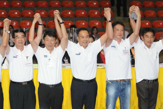 Somyot Poompunmuang, center, celebrates his football presidency victory on Feb. 11 in Bangkok.