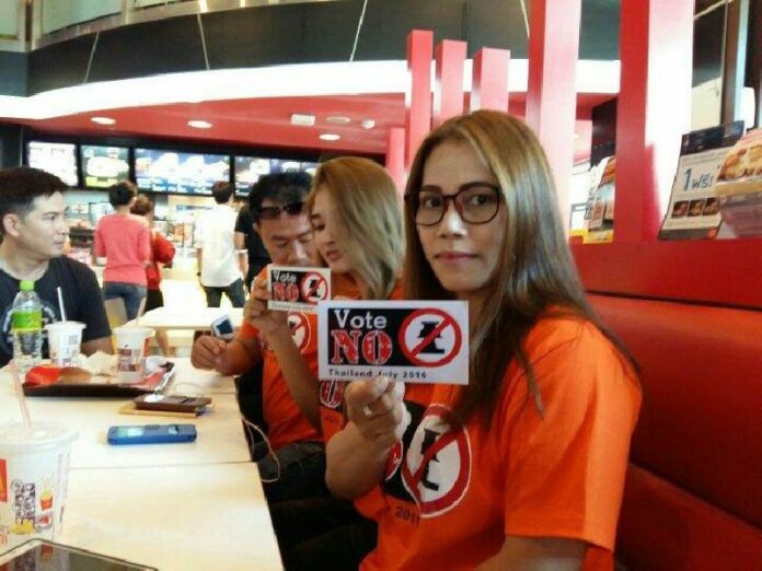 Opponents of the draft charter display stickers Sunday in a McDonald's near the Democracy Monument in Bangkok. Photo: Thai Lawyers for Human Rights