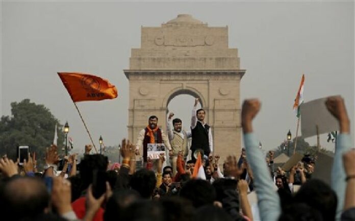 Members of Akhil Bharatiya Vidyarthi Parishad (ABVP), the student wing of the ruling Bharatiya Janata party, shout slogans during a protest in front of the India Gate in New Delhi, India, Friday, Feb. 12, 2016. Photo: Altaf Qadri / Associated Press