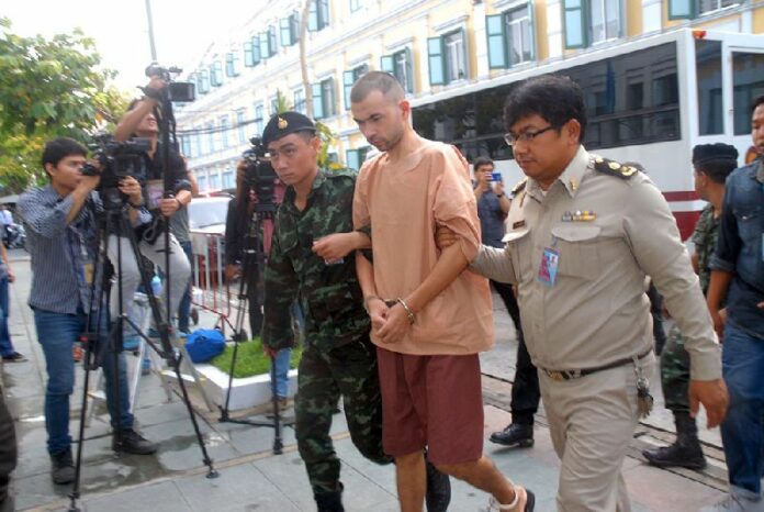 Bombing suspect Adem Karadag led Oct. 19 into the military court in Bangkok.<br />