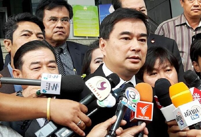 Former Prime Minister Abhisit Vejjajiva, head of the Democrat Party speaks to reporters Wednesday at the Appeal Court in Bangkok.<br />