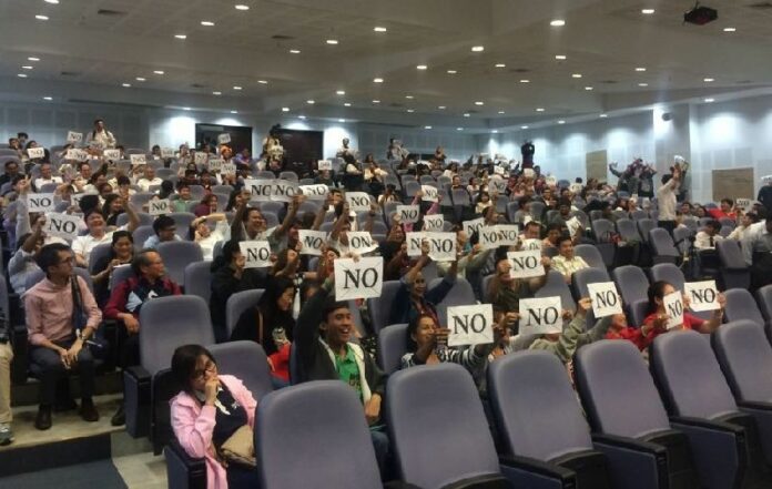 Audience members at a Chulalongkorn University seminar display their opposition Feb. 8 to the junta-sponsored draft charter in Bangkok.