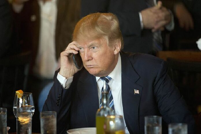 Republican presidential candidate Donald Trump listens to his mobile phone during a Thursday lunch stop in North Charleston, South Carolina. Photo: Matt Rourke / Associated Press