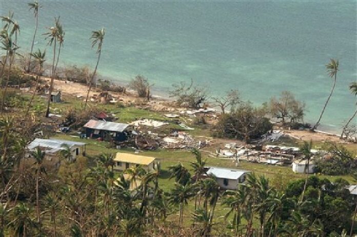 In this Sunday, Feb. 21, 2016 aerial photo supplied by the New Zealand Defense Force, debris is scattered around damaged buildings at Susui village in Fiji, after Cyclone Winston tore through the island nation. Photo: New Zealand Defense Force / Associated Press