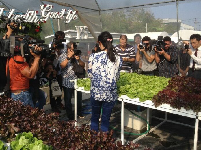 A crowd of foreign correspondents take photos of former Prime Minister Yingluck Shinawatra on Feb. 12 at her residence in Bangkok.