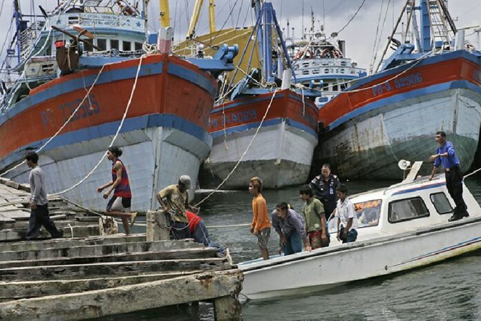 Burmese fishermen arrive at the compound of Pusaka Benjina Resources on April 3, 2015, to report themselves for departure to leave the fishing company in Indonesia as hundreds of foreign fishermen rushed at the chance to be rescued from the isolated island where an Associated Press report revealed slavery runs rampant in the industry. Photo: Dita Alangkara / Associated Press