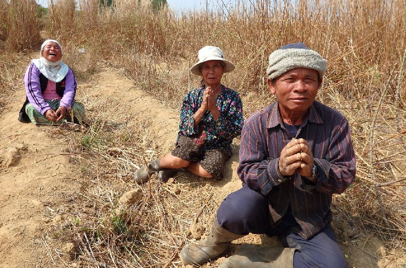 Locals pray for lottery fortune at the site of a crashed plane Thursday in Nakhon Phanom province.