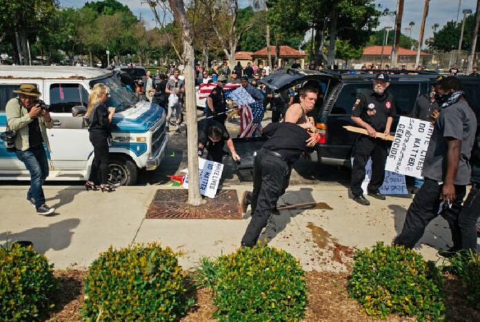 Counter-protesters in a scuffle with a KKK member during which he stabbed an attacking protester Saturday afternoon local time as members of the KKK try to start an anti-immigration rally in Anaheim, California.Photo: Eric Hood / OC Weekly via AP