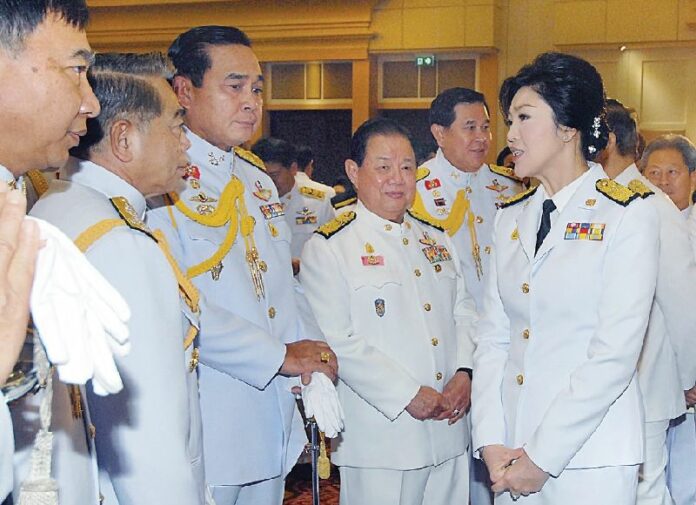 Prime Minister Yingluck Shinawatra talks with army chief on Gen. Prayuth Chan-ocha at the Army Club in Bangkok on Dec. 3, 2013, one week before she dissolved Parliament and called for fresh elections.