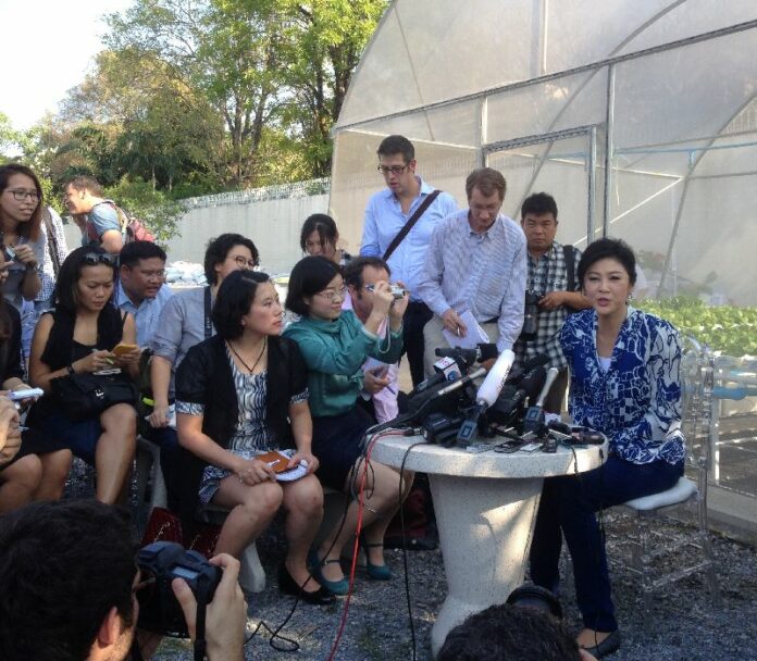Foreign correspondents are among a crowd of reporters interviewing former Prime Minister Yingluck Shinawatra on Feb. 12 at her home in Bangkok.