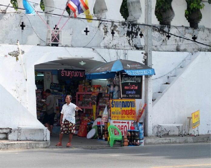 A woman sells fireworks near the old fort wall from which the Pom Mahakan community gets its name. More than 300 people live between the wall and Khlong Banglamphu, which the city declared eminent domain over in 1992 to build a park.