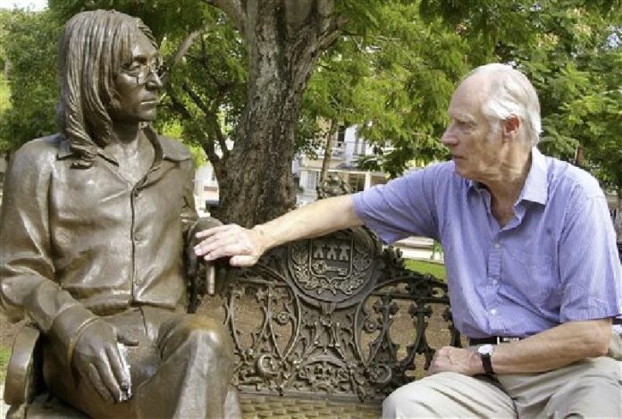 In this Oct. 30, 2002, file photo, Beatles producer George Martin touches a statue of John Lennon in a park in the Vedado neighborhood of Havana, during his visit to Cuba. Photo: Cristobal Herrera / Associated Press