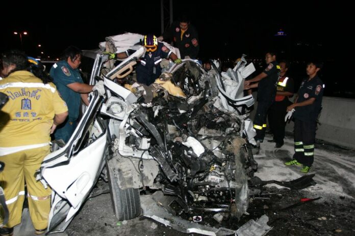 A Hyundai van sits wrecked Wednesday morning on the Bhumibol 1 Bridge in Bangkok. Two people inside died instantly.