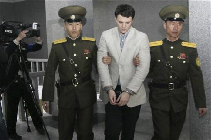 American student Otto Warmbier, center, is escorted at the Supreme Court in Pyongyang, North Korea, Wednesday, March 16, 2016. Photo: Jon Chol Jin / Associated Press