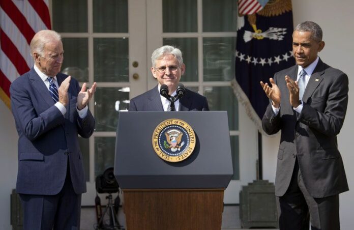 US Federal appeals court judge Merrick Garland receives applauds from President Barack Obama and Vice President Joe Biden as he is introduced as Obama's nominee for the Supreme Court Wednesday in Washington. Photo: Pablo Martinez Monsivais / Associated Press<br />
