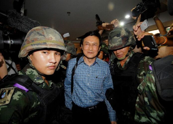 Former Education Minister Jaturon Chaisang is taken into custody by soldiers May 27, 2014, at the Foreign Correspondents' Club in Bangkok.