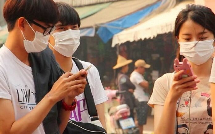 People wear masks to protect themselves from the haze in northern Thailand’s Chiang Rai province.
