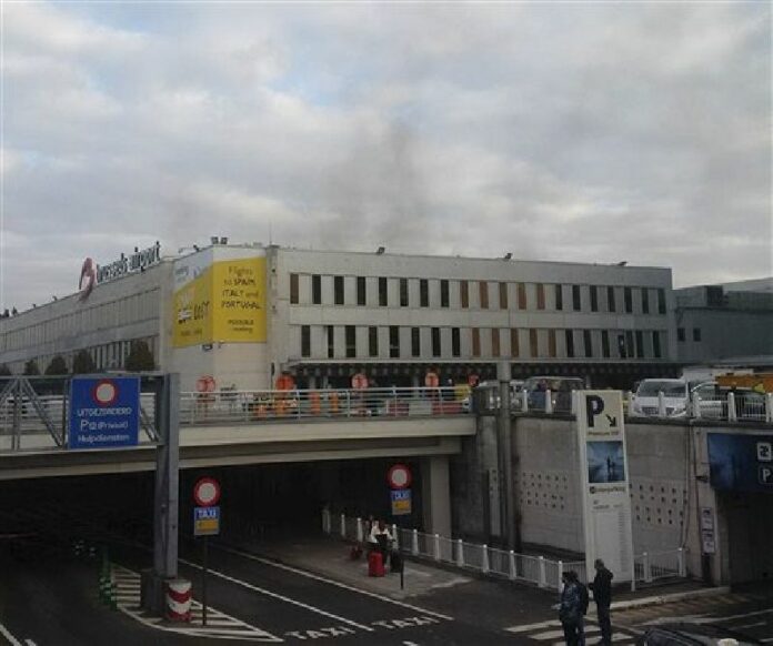 In this image provided by Daniela Schwarzer, smoke is seen at Brussels airport in Brussels, Belgium, after explosions were heard Tuesday, March 22, 2016. Photo: Daniela Schwarzer / Associated Press