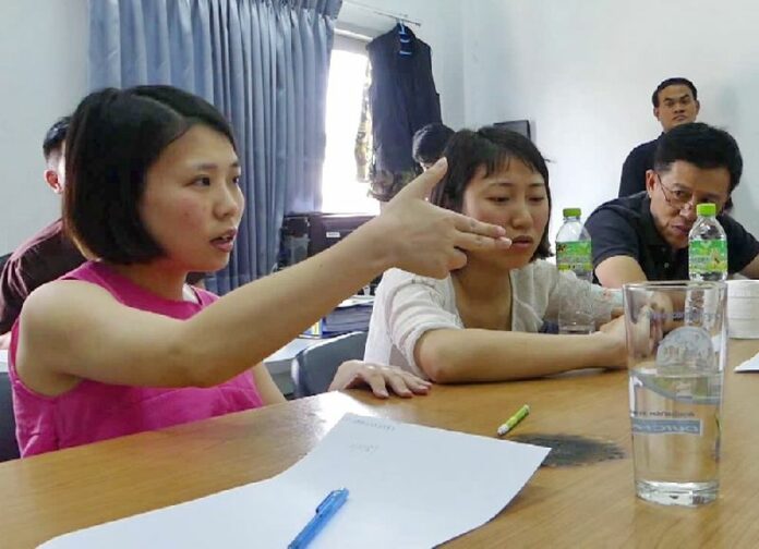 Two Chinese women provide testimony to police Tuesday at a Pathum Thani police station.