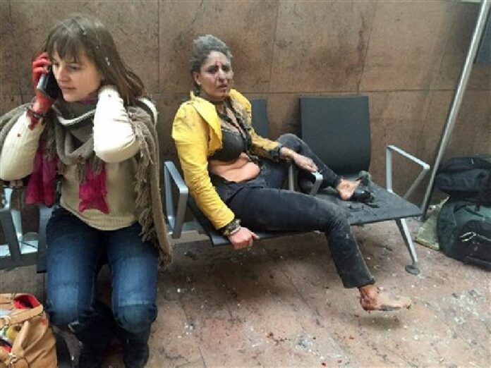 In this photo provided by Georgian Public Broadcaster and photographed by Ketevan Kardava two women wounded in Brussels Airport in Brussels, Belgium, after explosions were heard Tuesday, March 22, 2016. Photo: Ketevan Kardava / Georgian Public Broadcaster / Associated Press