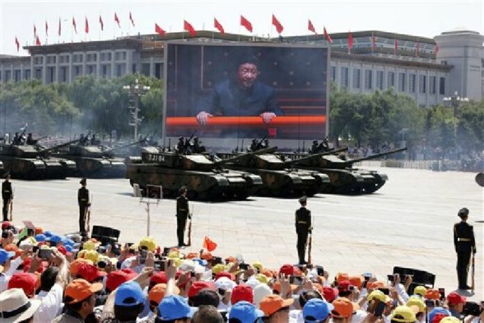 In this Thursday, Sept. 3, 2015 file photo, Chinese President Xi Jinping is displayed on a big screen as Type 99A2 Chinese battle tanks roll across during a parade commemorating the 70th anniversary of Japan's surrender during World War II from Tiananmen Gate, in Beijing. China said Friday, March 4, 2016. Photo: Ng Han Guan / Associated Press