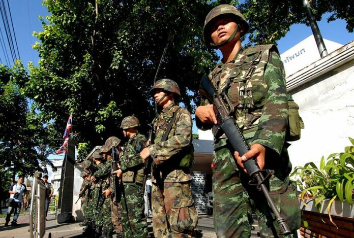 Soldiers posted outside an army auditorium where civilians were being brought in for ‘attitude adjustment’ one day after the coup on May 23, 2014, in Bangkok.