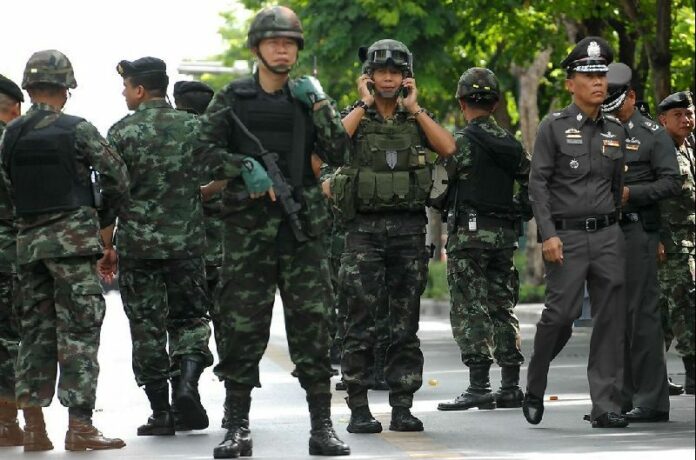 Soldiers posted outside an army auditorium where civilians were being brought in for ‘attitude adjustment’ one day after the coup on May 23, 2014, in Bangkok.