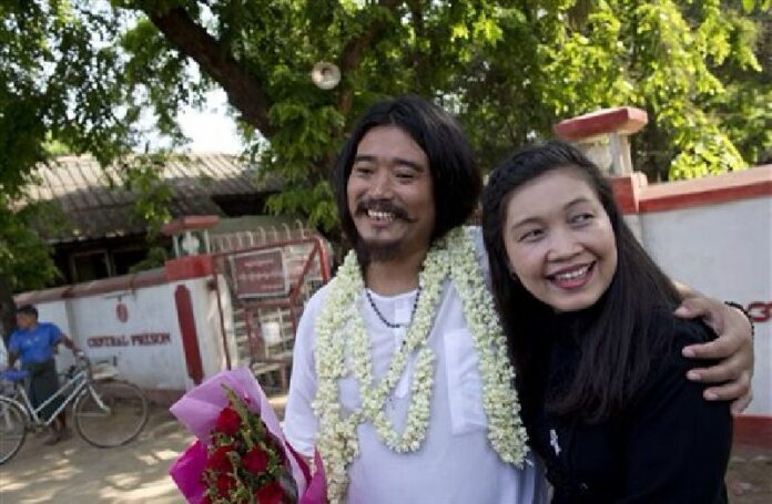 Ethnic Kachin activist Patrick Kum Ja Lee, left, smiles after posing for a picture with his wife and prominent Human Rights activist May Sabe Phyu, right, outside insein prison in Yangon, Myanmar, Friday, April 1, 2016. Photo: Gemunu Amarasinghe / Associated Press