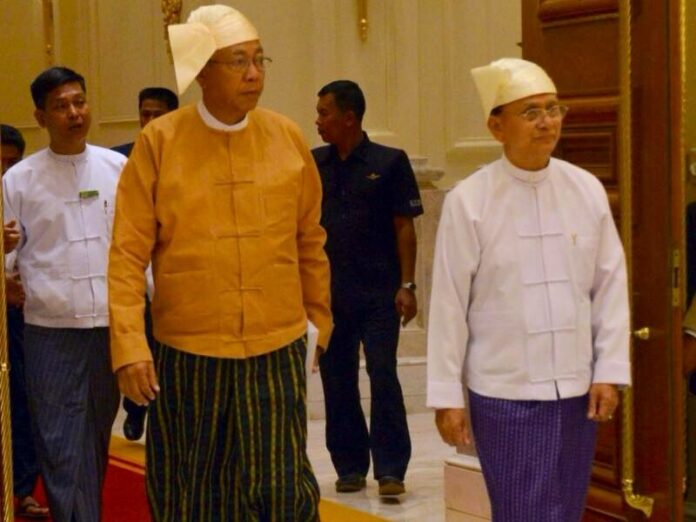 In an undated photo outgoing President Thein Sein, right, and his successor Htin Kyaw, walk into the diplomatic hall at the presidential residence in Nay Pyi Taw for a formal hand-over ceremony. (Photo: Ministry of Information)